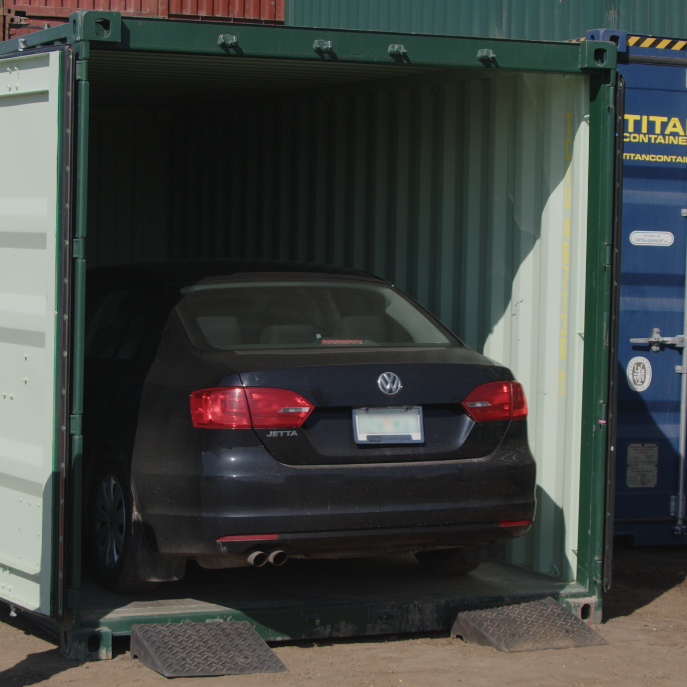 Rubber container ramps in use with car driving into a shipping container – heavy-duty entry ramps for easy vehicle access