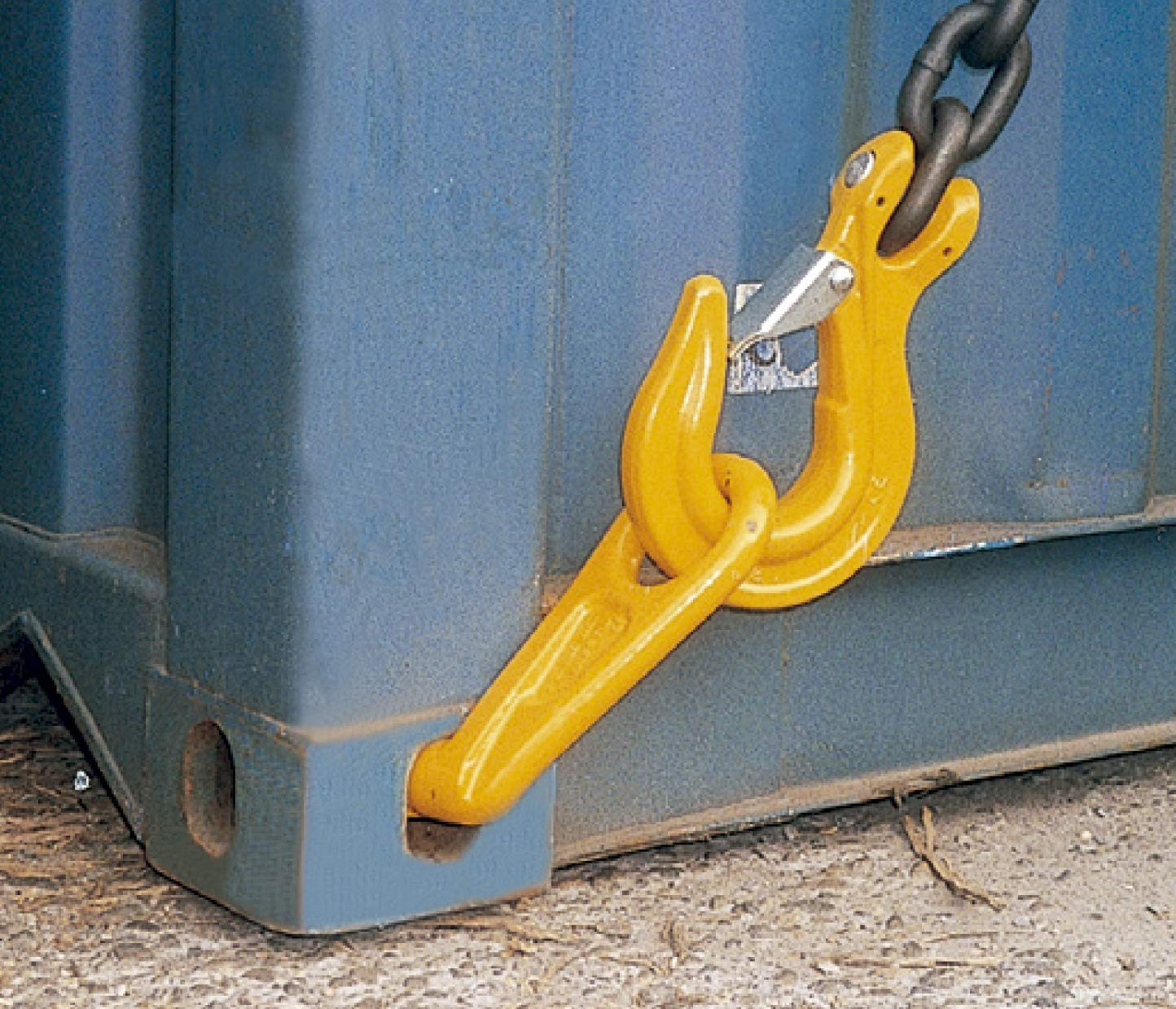 Yellow G80 sea container lifting hook securely attached to the corner casting of a blue shipping container, connected to a lifting chain for hoisting operations.