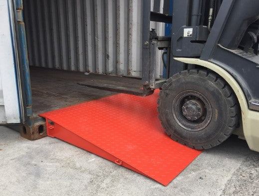 Forklift using heavy-duty steel container ramp for easy loading into shipping container — 18,000 lb capacity, reinforced checker plate design.