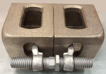 Bridge fitting shown securing two shipping container corner castings together side by side. Heavy-duty galvanized steel connection for flush horizontal container coupling.